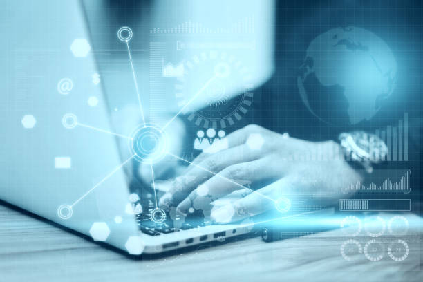 istock Close up of hand using laptop with abstract global digital business interface on blurry background. Interface, chart and hud concept. Double exposure. 1387974102