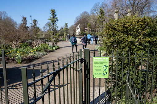 People walking through Rose Garden at Hyde Park in City of Westminster, London