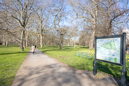 Map of Green Park at Green Park in City of Westminster, London, including an illustrated map and people in the background.