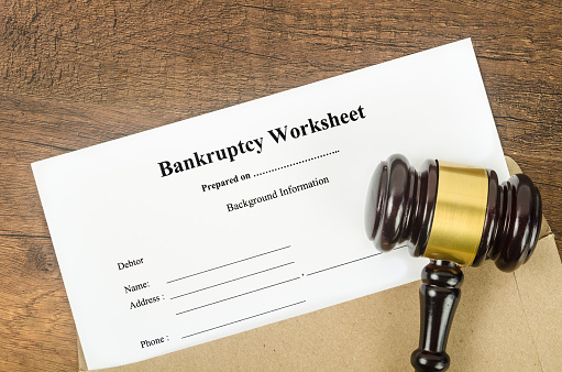 The Wooden Gavel and bankruptcy worksheet documents. Law Concepts.
