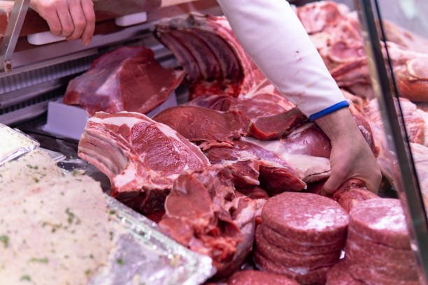 istock Close up man's hands working on butcher's shop 1387975786