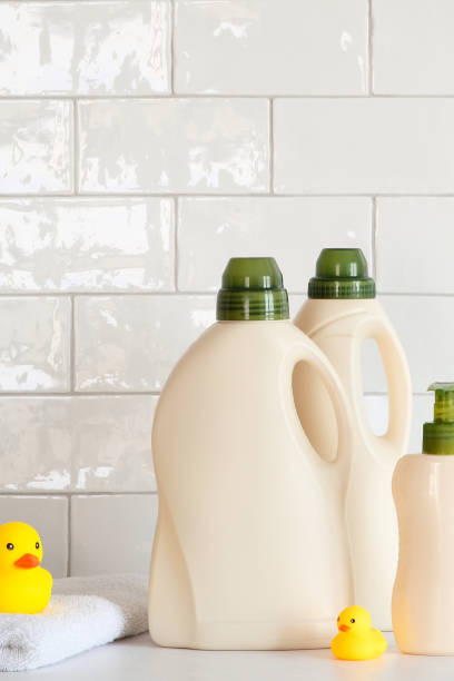 istock Laundry detergent products packaging design, branding. Detergent bottles, towel and yellow ducks. White tiles on background. 1387977152