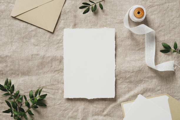 istock Wedding stationery set and wedding invitation card template on linen cloth top view. Rustic, vintage style. 1387977222