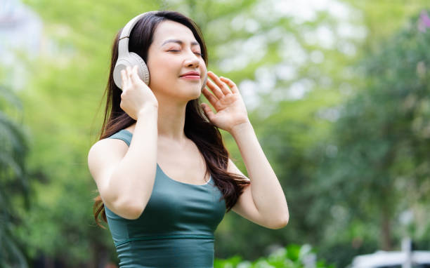 istock Asian woman exercising at the park 1387977302