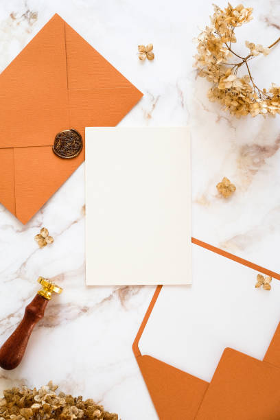 istock Autumn flat lay composition with wedding invitation card mockup, golden rings, envelopes, dried flowers on marble table. Wedding stationery set 1387977329