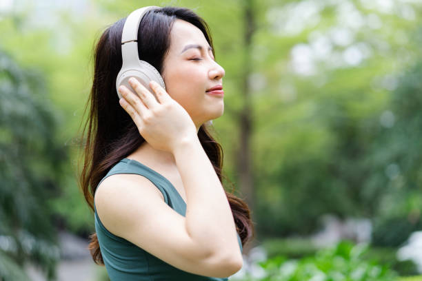 istock Asian woman exercising at the park 1387977393