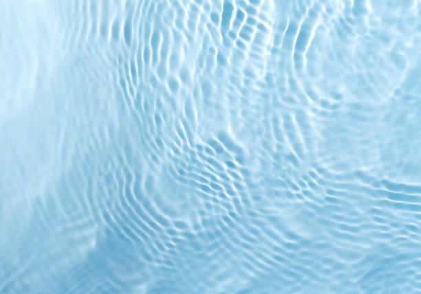 lurred transparent blue colored water surface stock photo