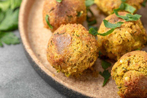 istock Chickpea falafel with lime and sauce on a plate and grey table close up 1387979398