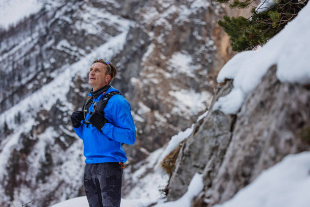 istock A Caucasian Trail Runner Pauses At Mountain Top In Winter 1387979416