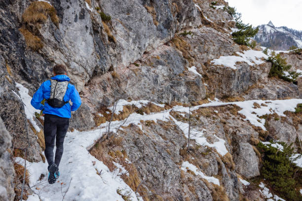 istock A Rear View Of Athletic Man Trail Running In Winter 1387979430