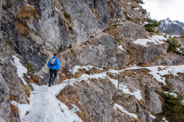 istock A Rear View Of Athletic Man Trail Running In Winter 1387979433