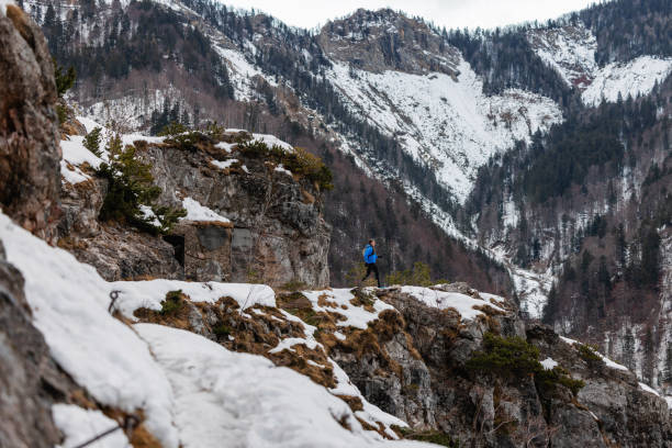 istock A Caucasian Trail Runner Taking A Run On A Snowy Mountain Path 1387979444