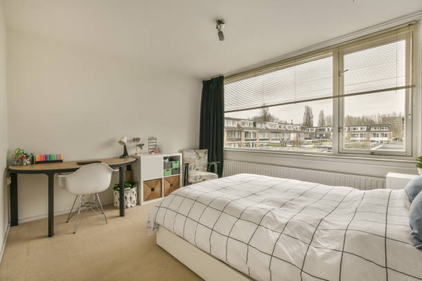 istock A bedroom with a bed with a checkered bedspread 1387979749
