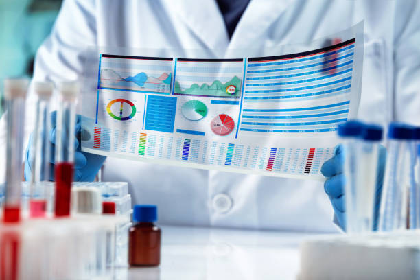 Researcher Analyzing Test Results Report in Medical Research Laboratory stock photo