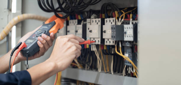 istock Electrician engineer work tester measuring voltage and current of power electric line in electical cabinet control , concept check the operation of the electrical system . 1387983394