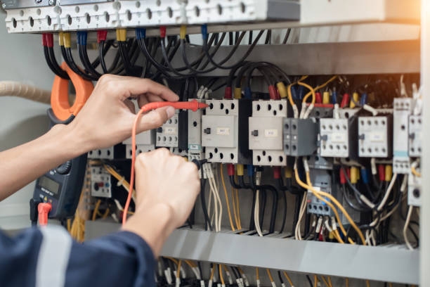 istock Electrician engineer work tester measuring voltage and current of power electric line in electical cabinet control , concept check the operation of the electrical system . 1387983396