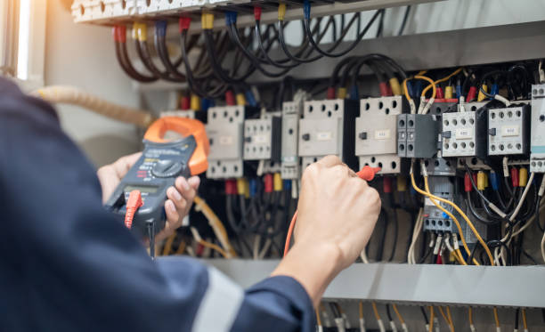 istock Electrician engineer work tester measuring voltage and current of power electric line in electical cabinet control , concept check the operation of the electrical system . 1387983397