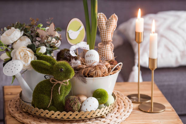 istock Rustic. White-green colors. Iron planters with Easter eggs, flowers, candles and rabbits in the living room interior on the table. The concept of home comfort in the bright holiday of Easter 2022. 1387983716