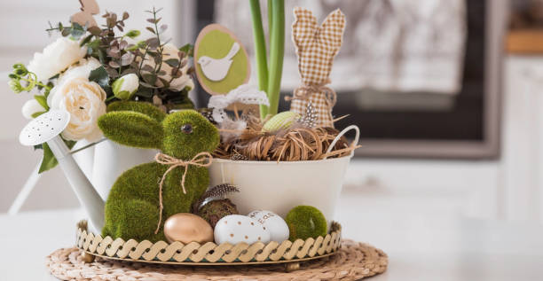 istock An iron pot with Easter eggs, flowers and rabbits on the table.In the background is a white Scandinavian-style kitchen. The concept of home comfort and decor in the bright holiday of Easter 2022. 1387983720