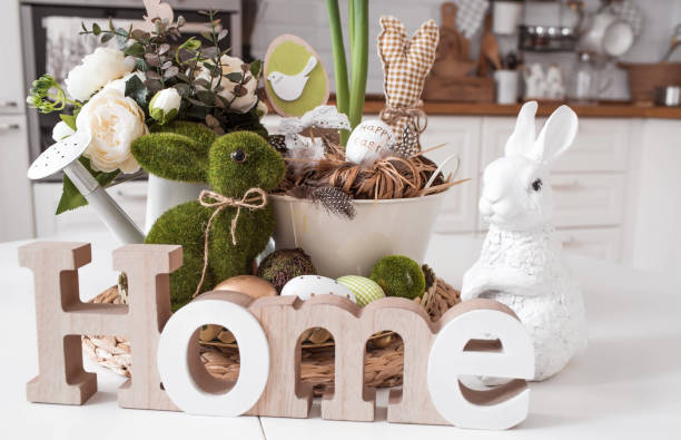 istock An iron pot with Easter eggs, flowers and rabbits on the table.In the background is a white Scandinavian-style kitchen. The concept of home comfort and decor in the bright holiday of Easter 2022. 1387983723