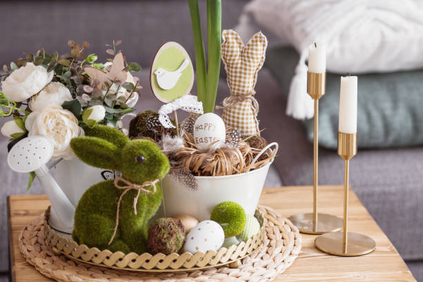 istock Rustic. White-green colors. Iron planters with Easter eggs, flowers, candles and rabbits in the living room interior on the table. The concept of home comfort in the bright holiday of Easter 2022. 1387983730