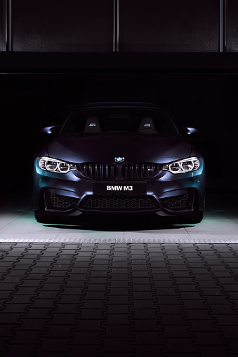 The front of the BMW M3 30 Jahre Edition standing in a dark garage. Limited edition created to celebrate the 30th anniversary of the M3. 500 pcs only, 450 hp. Katowice, Poland,  12.03.2016