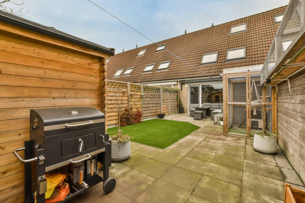 istock Cozy backyard with a small lawn and barbecue equipment 1387989083