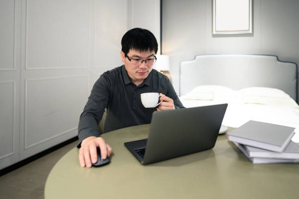 istock A middle-aged Asian white-collar man who works from home and drinks coffee 1387989201