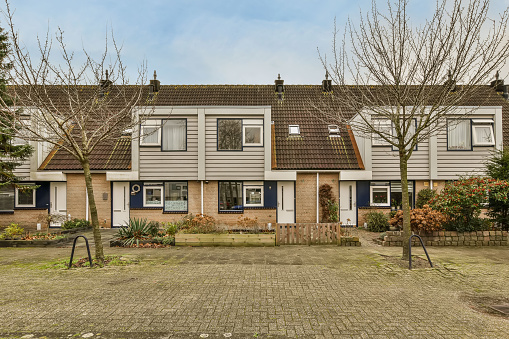 A private house with a small vegetable garden at the house and a brick-lined path