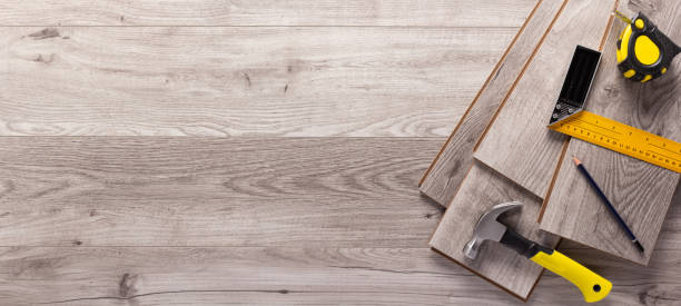 istock Wood laminate and tools on floor background texture. Wooden laminate top view 1387990135