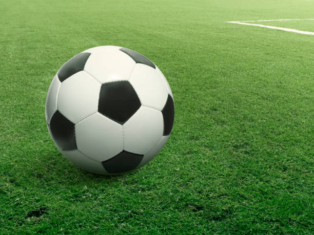 istock Traditional soccer ball on soccer field 1387990149