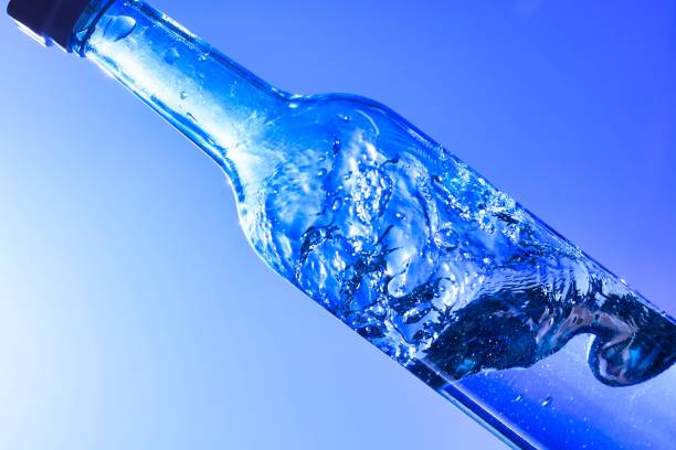Liquids and bubbles in a blueback bottle stock photo