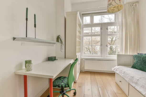 istock A bedroom with a large white bed and a work space 1387991507