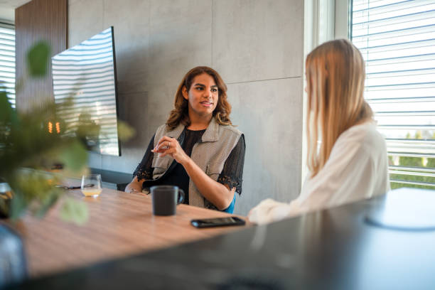 istock Young Caucasian Woman And Her Non-Binary Friend Chatting At Home 1387993201