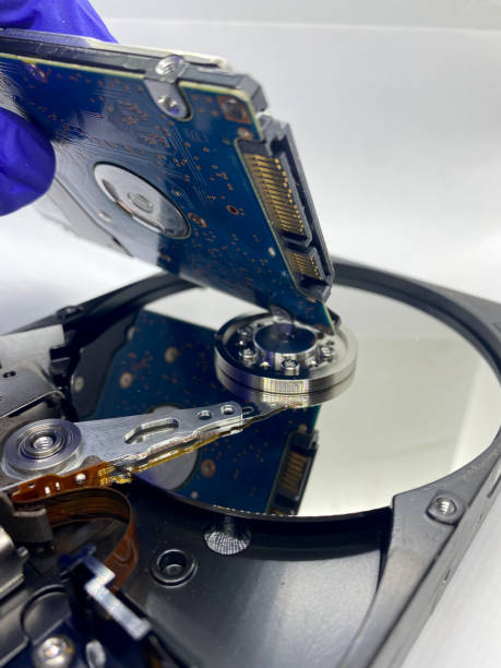 istock Closeup of small hard disk reflections on silver plate of a hard disk isolated on white 1387996025