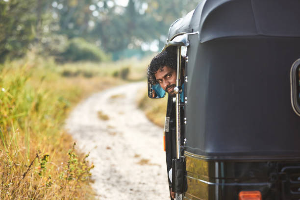 Portrait of tuk tuk driver on rural road Portrait of tuk tuk driver on rural road. Popular three wheeled motorcycle in Sri Lanka. "n taxi sri lanka stock pictures, royalty-free photos & images