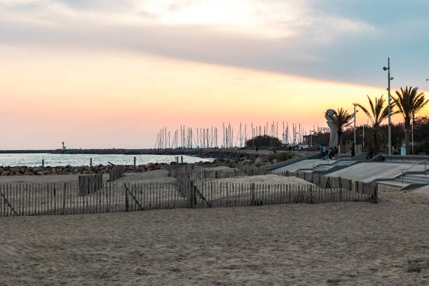Beach and seafront of La Grande-Motte at sunset (Occitanie, France)