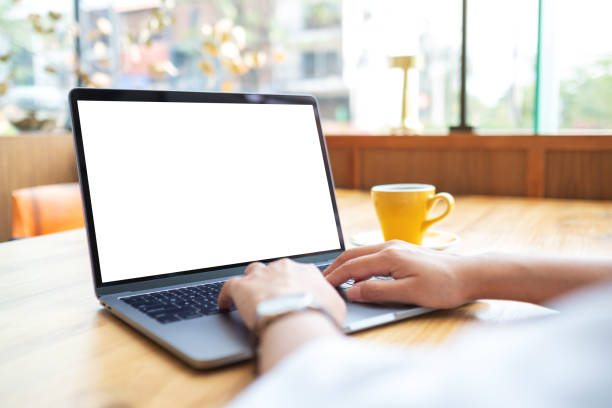 istock Mockup image of a woman using and working on laptop touchpad with blank white desktop screen 1388003774