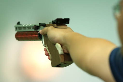 Preparation - Human hand holding air pistol for10m shooting