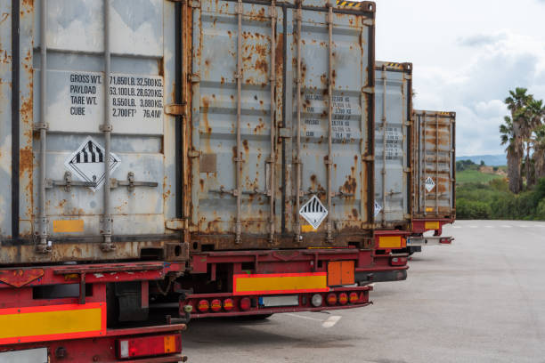 istock Rear view of several trucks with containers labeled with dangerous goods, ADR. 1388004040