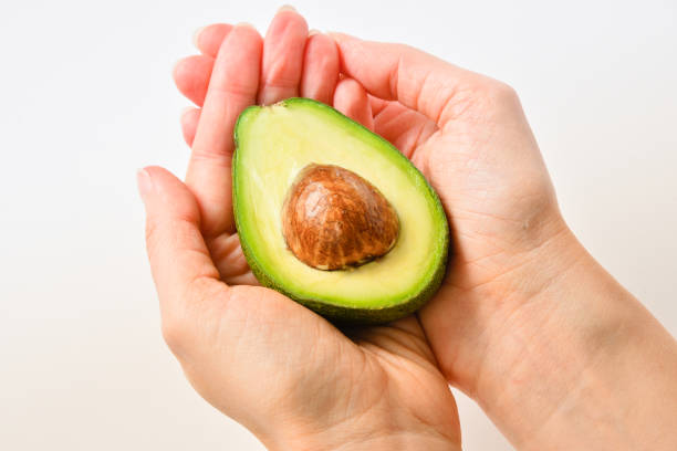 istock Avocado fresh orcanic food holding in hand 1388004333