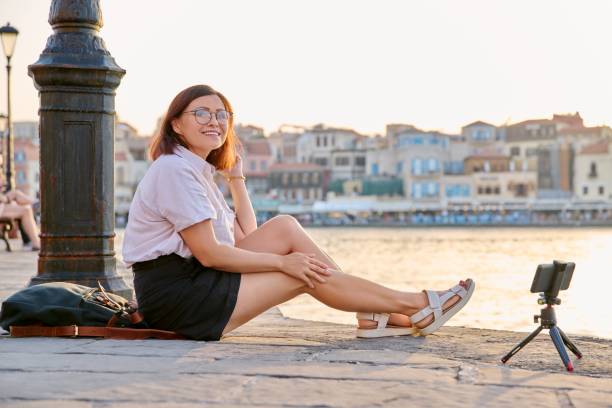 istock Woman recording stream on a smartphone on a tripod. 1388004404