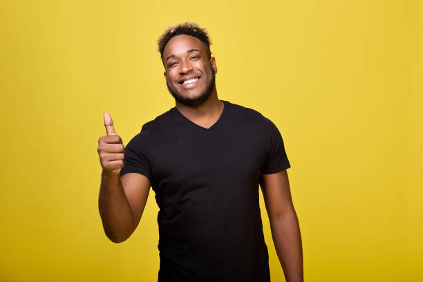 Satisfied young man shows positive hand gesture, he is satisfied with everything