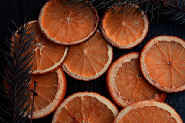 istock Halves of dried orange with Christmas tree branches 1388008576
