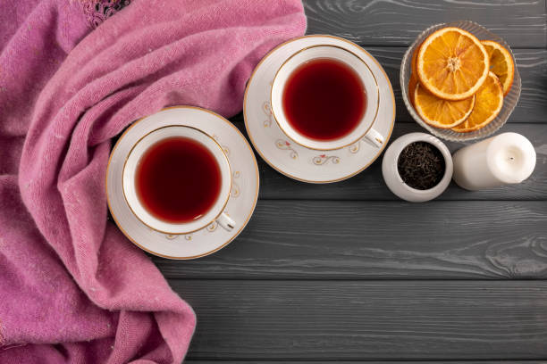 istock Winter composition, scarf and tea with oranges on the table 1388008615