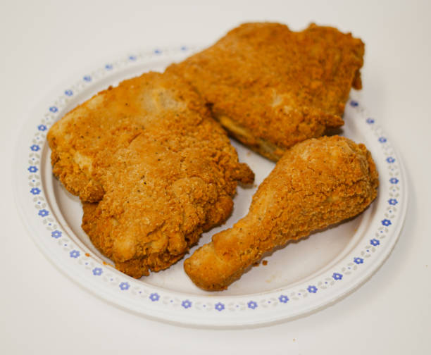istock Three pieces of fried chicken in a plate on white background 1388008645