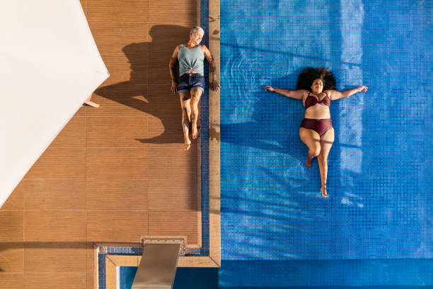 istock Women of different bodies relaxing in the pool 1388009277