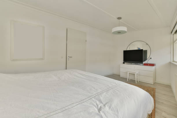 istock A small bedroom with a double bed in white 1388015745
