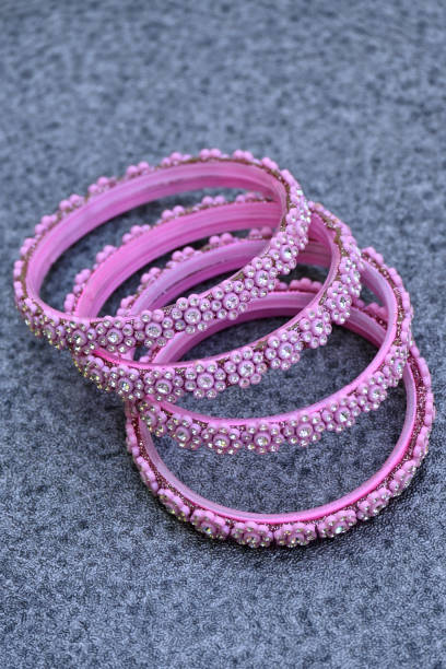 istock closeup the bunch pink silver bangle over out of focus grey background. 1388016868
