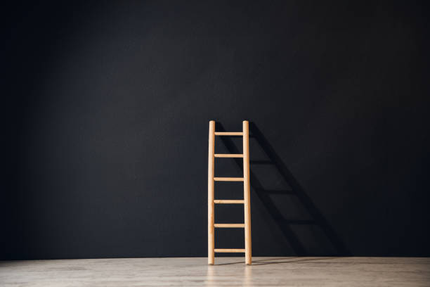 istock wooden stairs on black background 1388017035